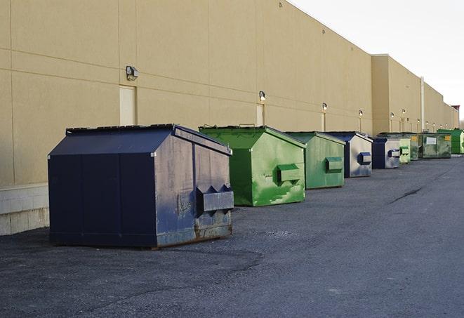 an aerial view of construction dumpsters placed on a large lot in Bude